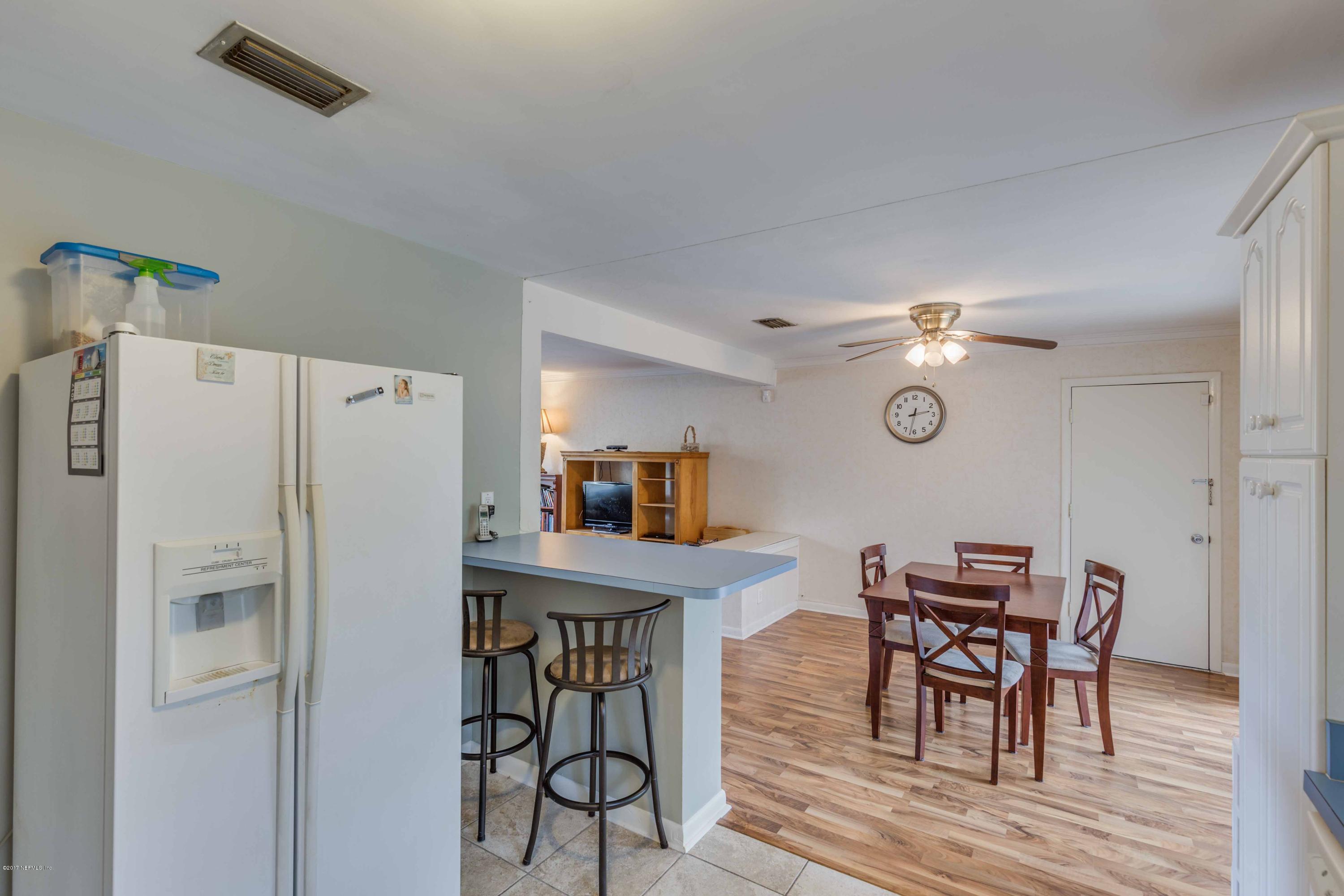 4020 Rogero Road Jacksonville, FL 32277 - Photo 12 of 23 a view of a dining room with furniture and a refrigerator