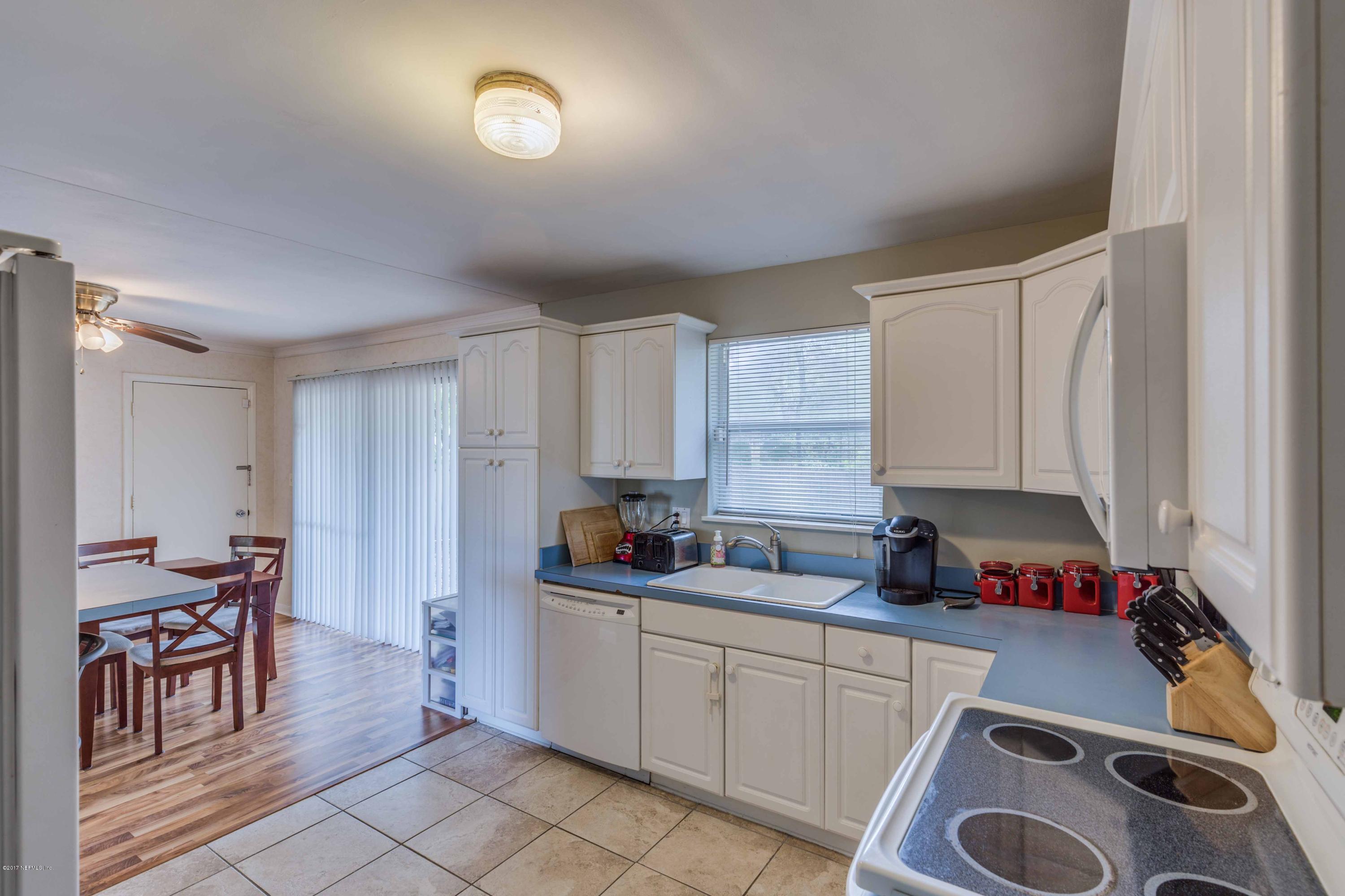 4020 Rogero Road Jacksonville, FL 32277 - Photo 13 of 23 a kitchen with cabinets and window