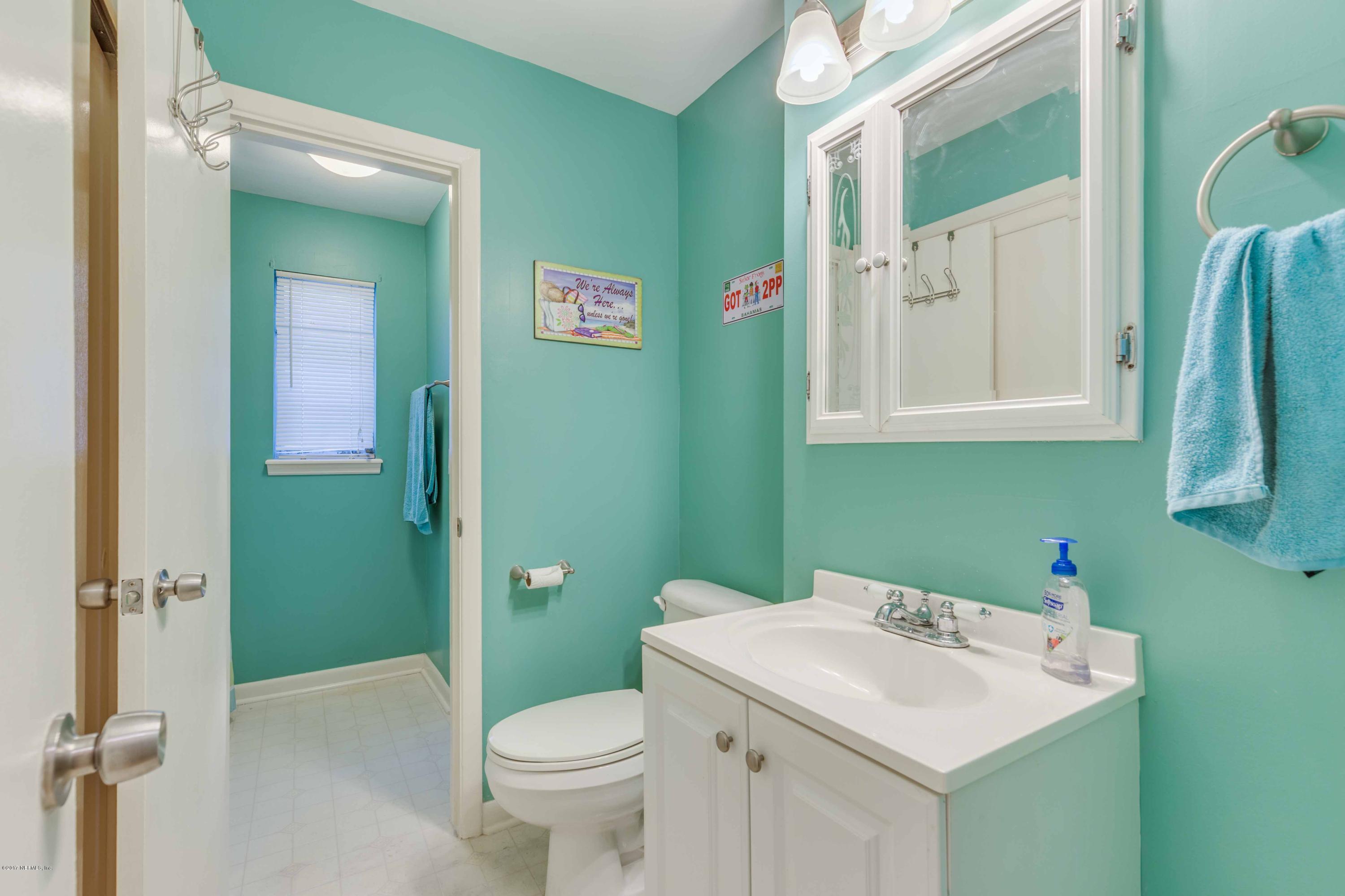 4020 Rogero Road Jacksonville, FL 32277 - Photo 14 of 23 a bathroom with a sink a toilet and a mirror