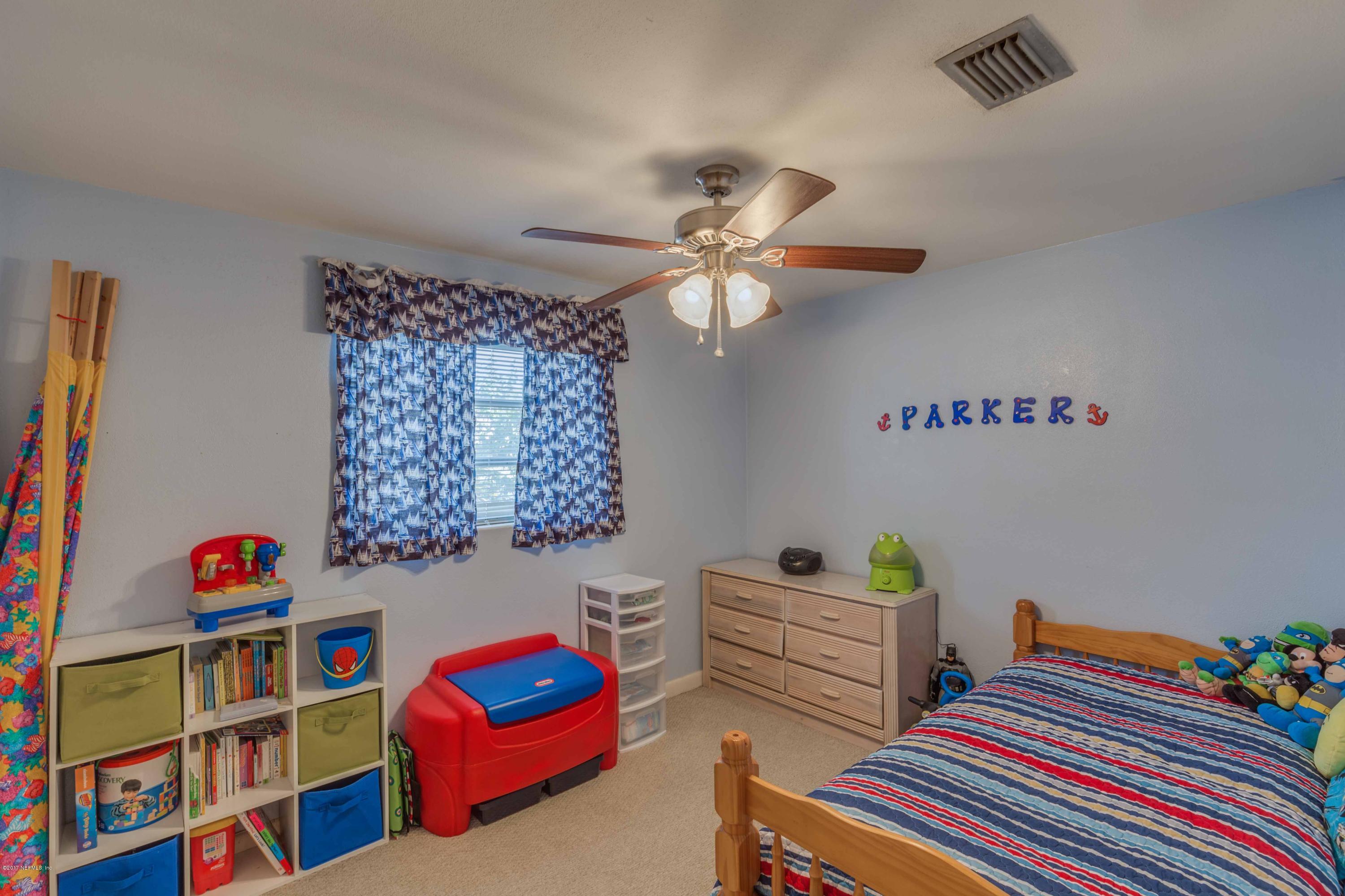 4020 Rogero Road Jacksonville, FL 32277 - Photo 16 of 23 a bedroom with furniture and a book shelf