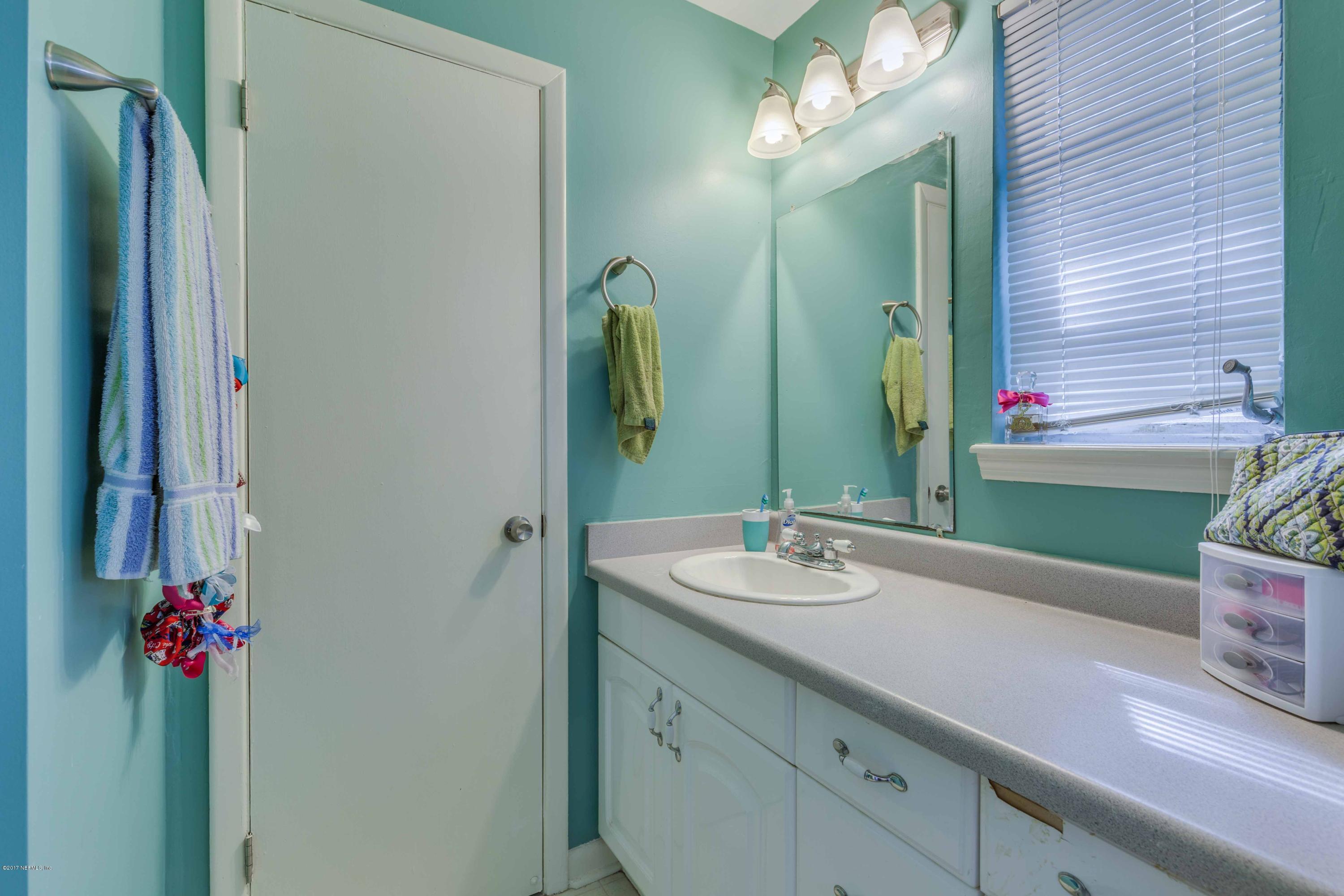 4020 Rogero Road Jacksonville, FL 32277 - Photo 17 of 23 a bathroom with a sink and a mirror