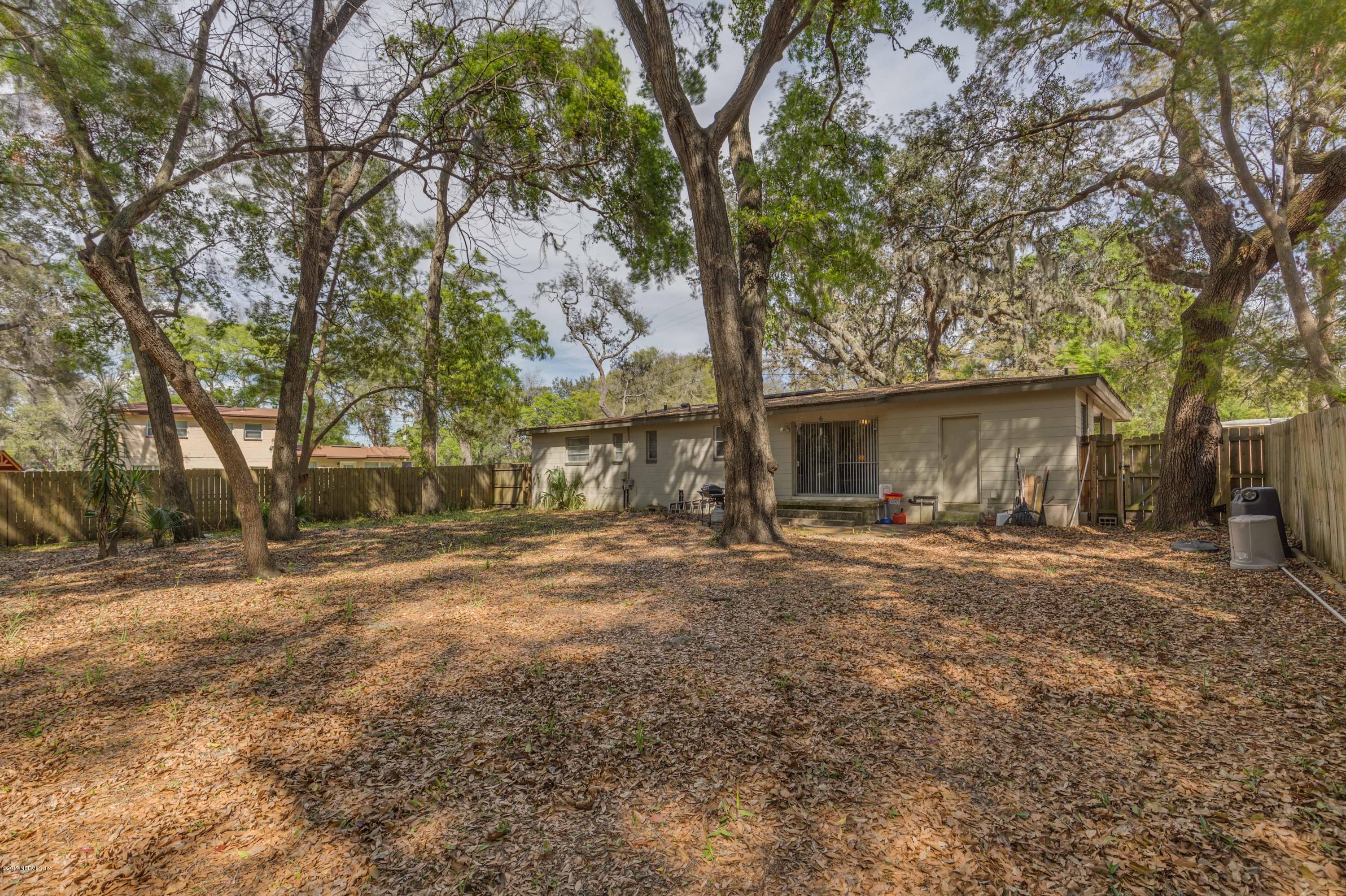 4020 Rogero Road Jacksonville, FL 32277 - Photo 21 of 23 a view of a house with yard and a tree