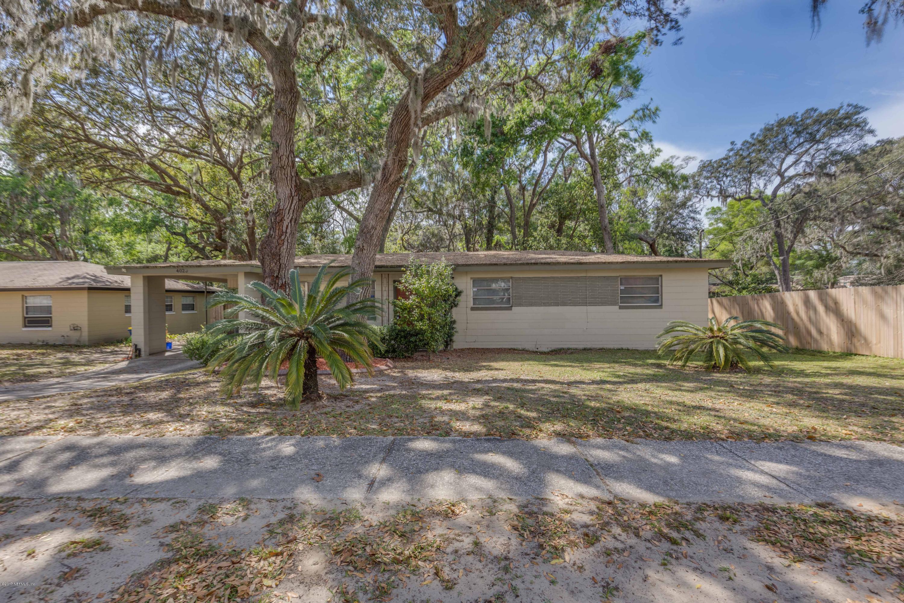 4020 Rogero Road Jacksonville, FL 32277 - Photo 3 of 23 a view of a yard with a house and a large tree