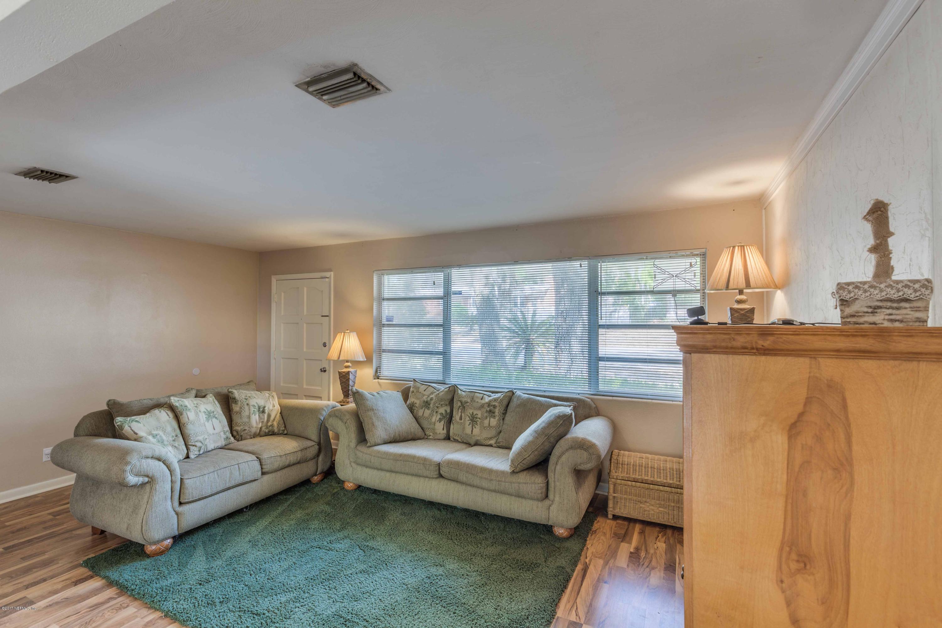 4020 Rogero Road Jacksonville, FL 32277 - Photo 7 of 23 a living room with furniture and a large window