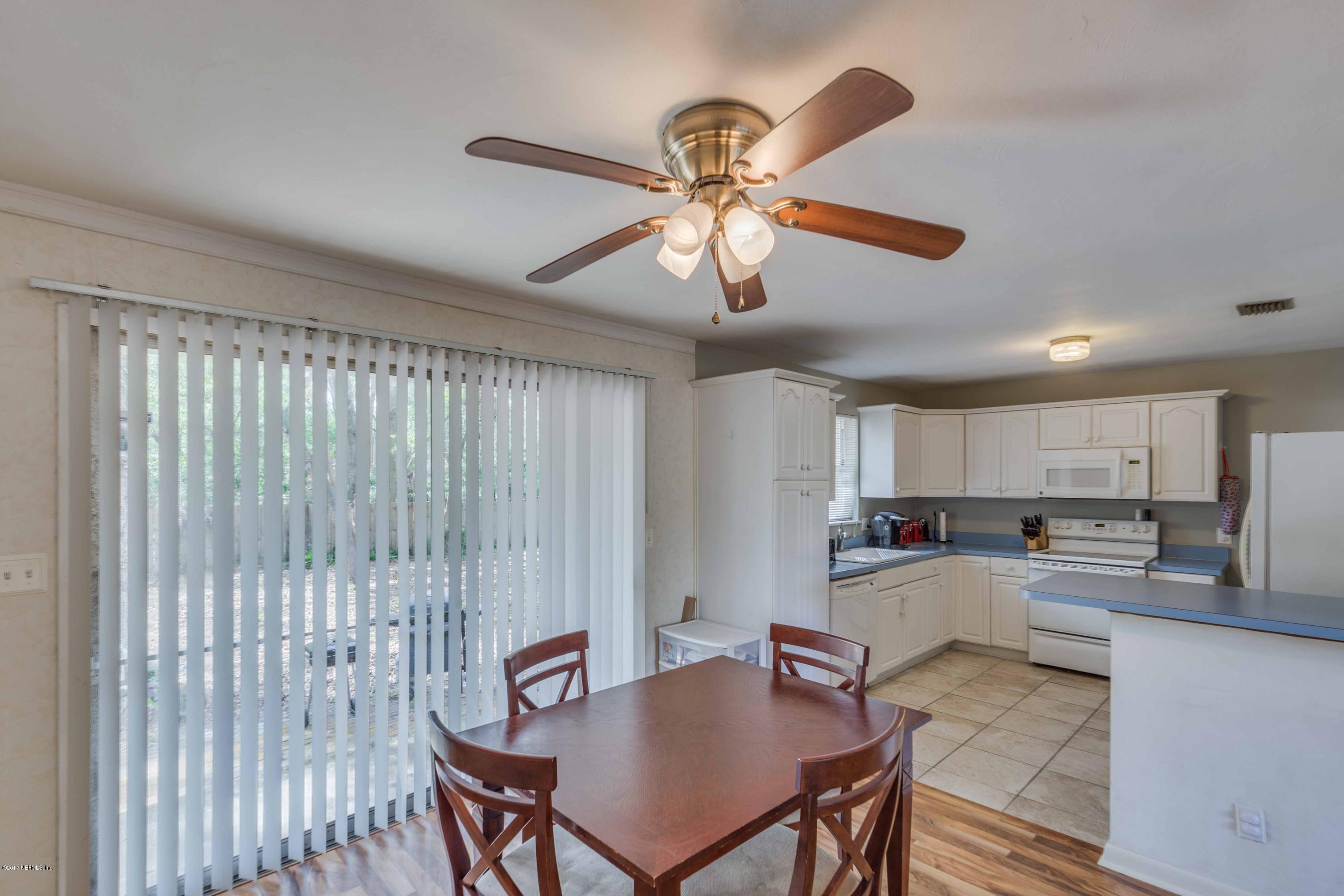 4020 Rogero Road Jacksonville, FL 32277 - Photo 9 of 23 a kitchen with a dining table chairs and refrigerator
