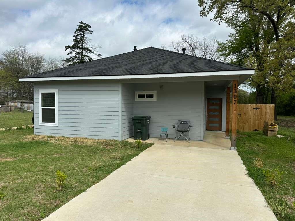 1307 West 33rd Street Tyler, TX 75702 - Photo 1 of 11 a front view of a house with a garden