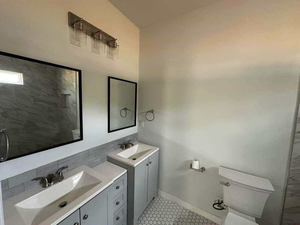 1307 West 33rd Street Tyler, TX 75702 - Photo 6 of 11 a bathroom with a sink and mirror