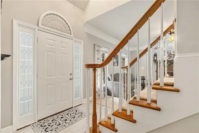 a view of staircase with white walls and a window