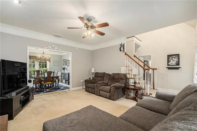 a living room with furniture and a flat screen tv with wooden floor