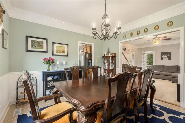 a view of a dining room with furniture and chandelier