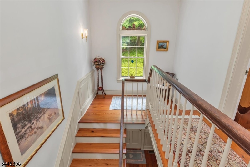 911 Ravine Road Port Murray, NJ 07865 - Photo 16 of 50 a view of staircase with wooden floor and a large window