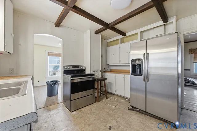 a kitchen with a refrigerator and a stove