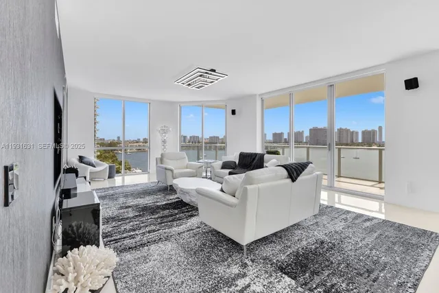 a living room with furniture and a view of kitchen