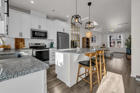 a view of a dining room with furniture and wooden floor