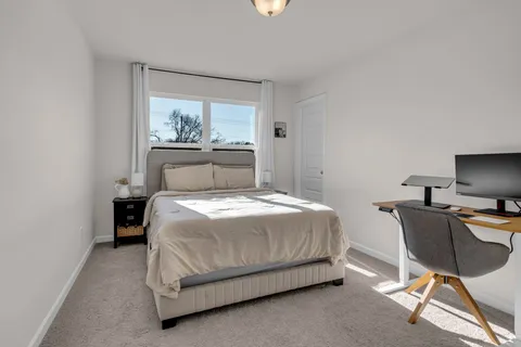 a bedroom with a flat screen tv and a bed