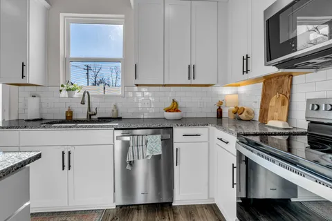 a kitchen with stainless steel appliances a refrigerator stove microwave and cabinets