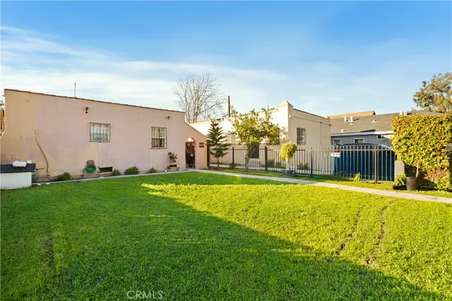 a house view with swimming pool in front of it