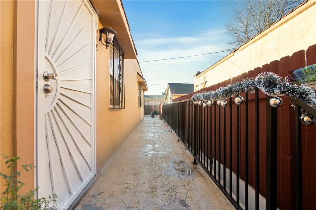 8449 Main Street Los Angeles, CA 90003 - Photo 13 of 17 a view of a pathway of a house with wooden fence
