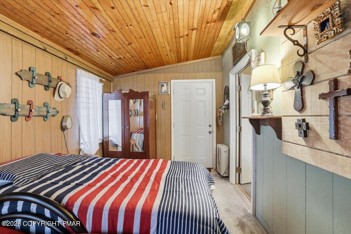 47 Red Wing Path Gouldsboro, PA 18424 - Photo 31 of 51 a bedroom with a bed and a chandelier