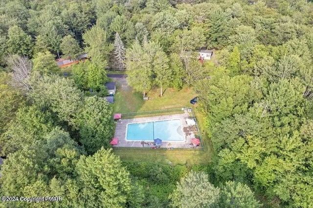 a aerial view of a house with a yard and lake view