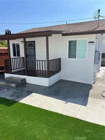a view of a house with a yard and deck