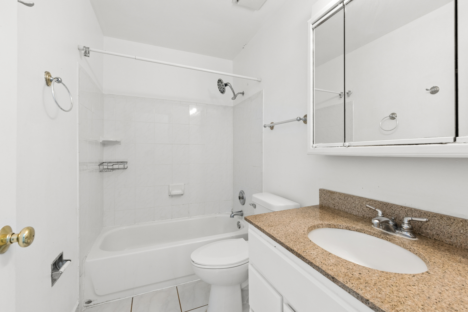 2213 West Nichols Road, Unit B Arlington Heights, IL 60004 - Photo 13 of 23 a bathroom with a granite countertop sink a toilet and shower