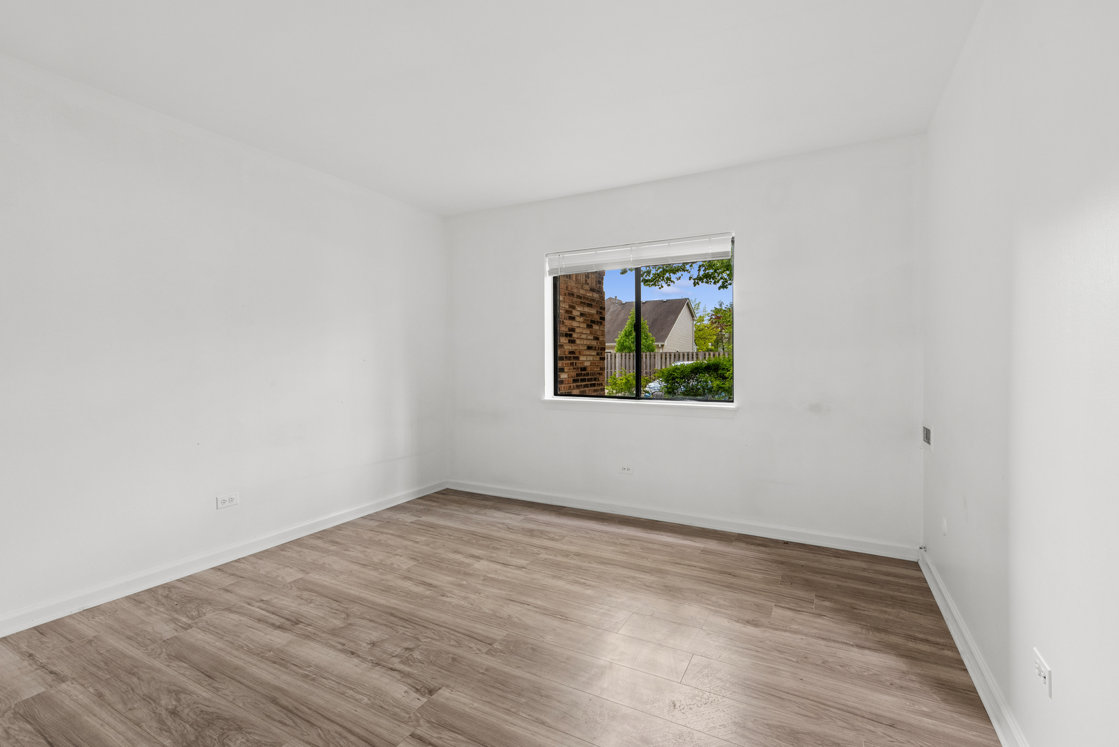 2213 West Nichols Road, Unit B Arlington Heights, IL 60004 - Photo 14 of 23 an empty room with wooden floor and window