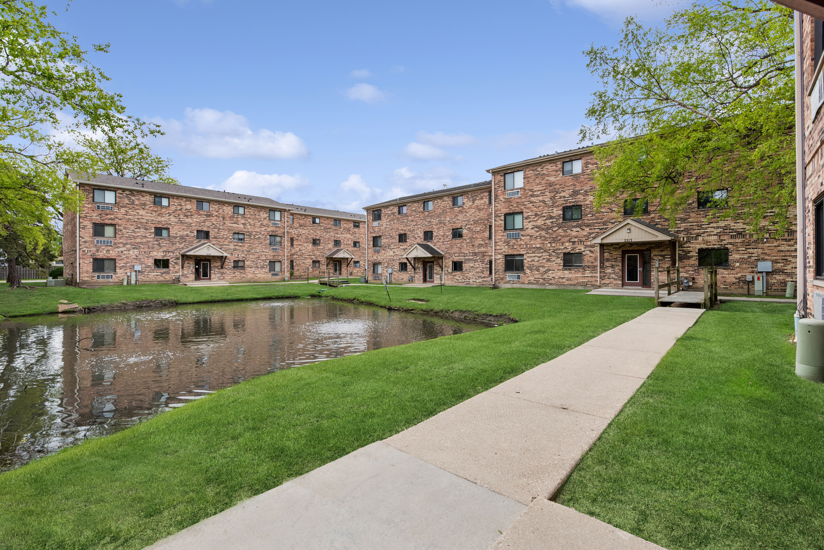 2213 West Nichols Road, Unit B Arlington Heights, IL 60004 - Photo 18 of 23 a view of a lake with a big yard and large trees