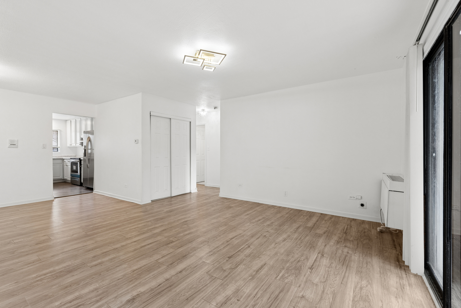 2213 West Nichols Road, Unit B Arlington Heights, IL 60004 - Photo 3 of 23 a view of an empty room with wooden floor