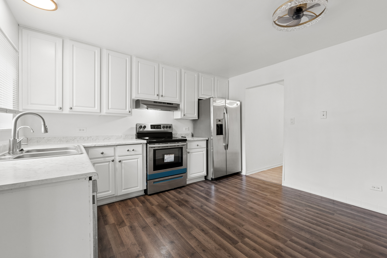 2213 West Nichols Road, Unit B Arlington Heights, IL 60004 - Photo 7 of 23 a kitchen with granite countertop a refrigerator sink and cabinets