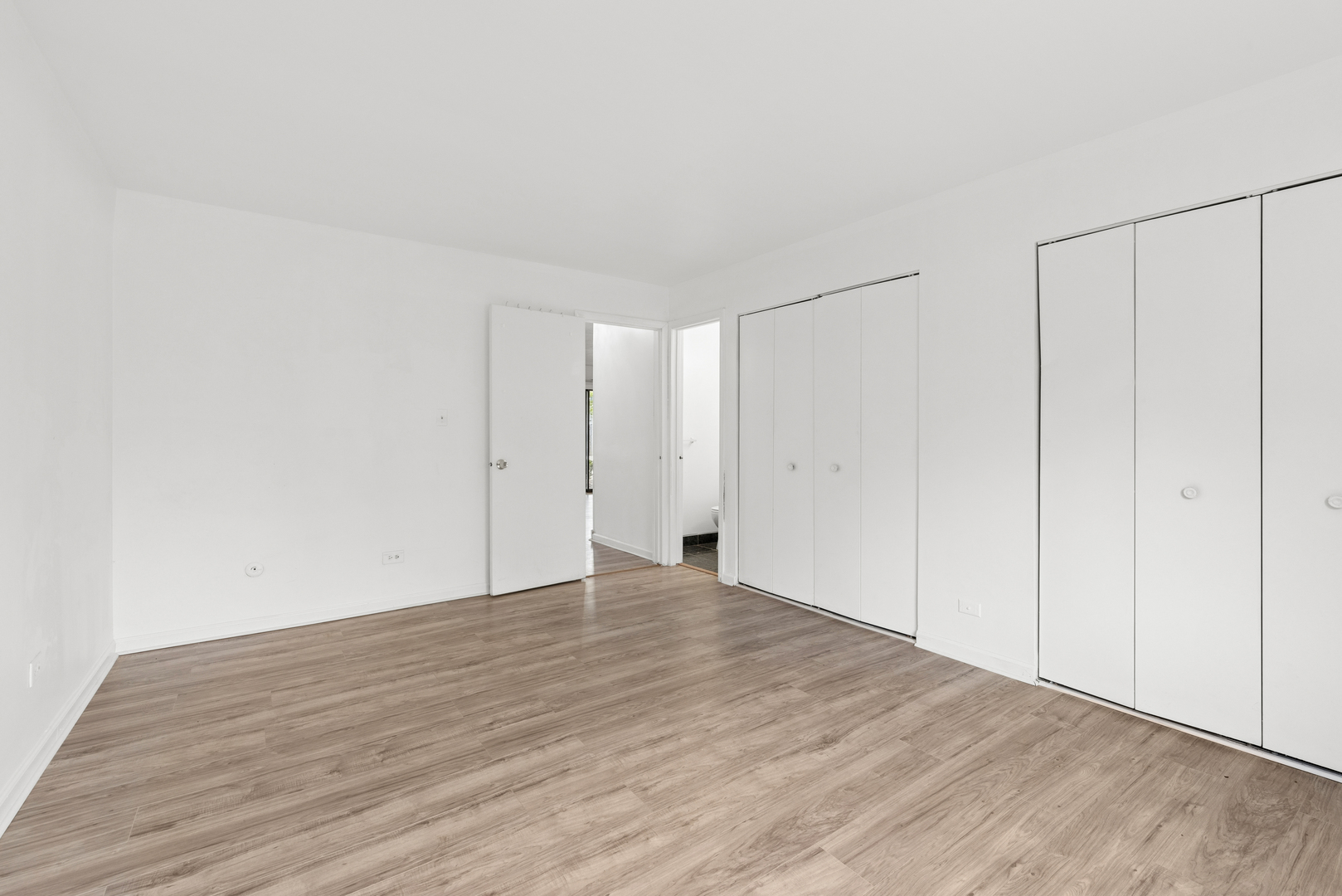 2213 West Nichols Road, Unit B Arlington Heights, IL 60004 - Photo 10 of 23 a view of an empty room with wooden floor