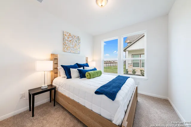 a bed sitting in a bedroom next to a window