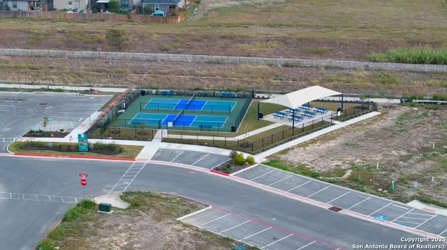 a view of backyard with wooden fence