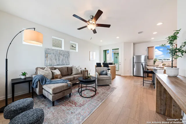 a living room with furniture and a wooden floor