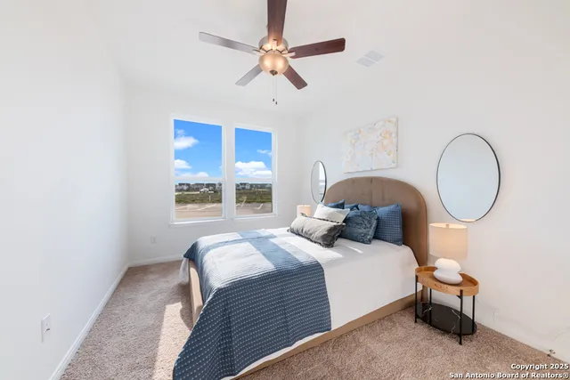 a bedroom with a bed a chandelier and a window