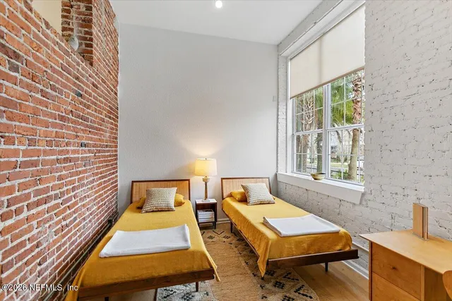 a living room with furniture and a refrigerator