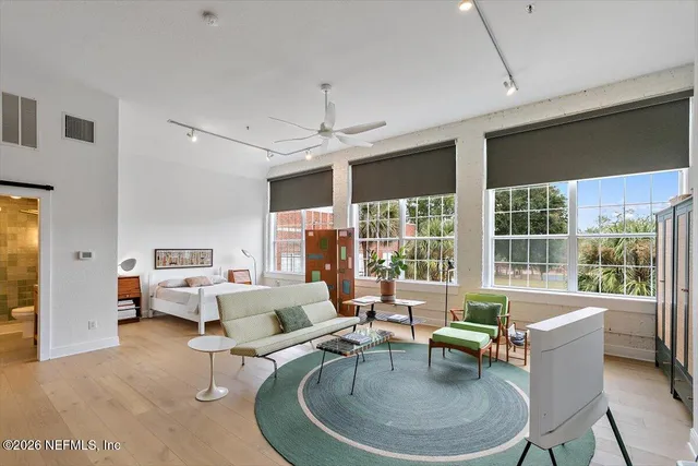 a living room with furniture and a floor to ceiling window