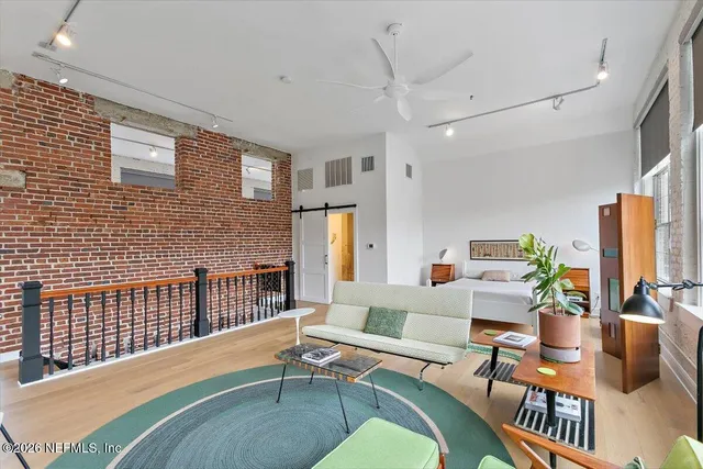 a bedroom with a bed window and a couch