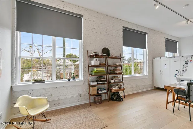 a dining room with furniture and wooden floor