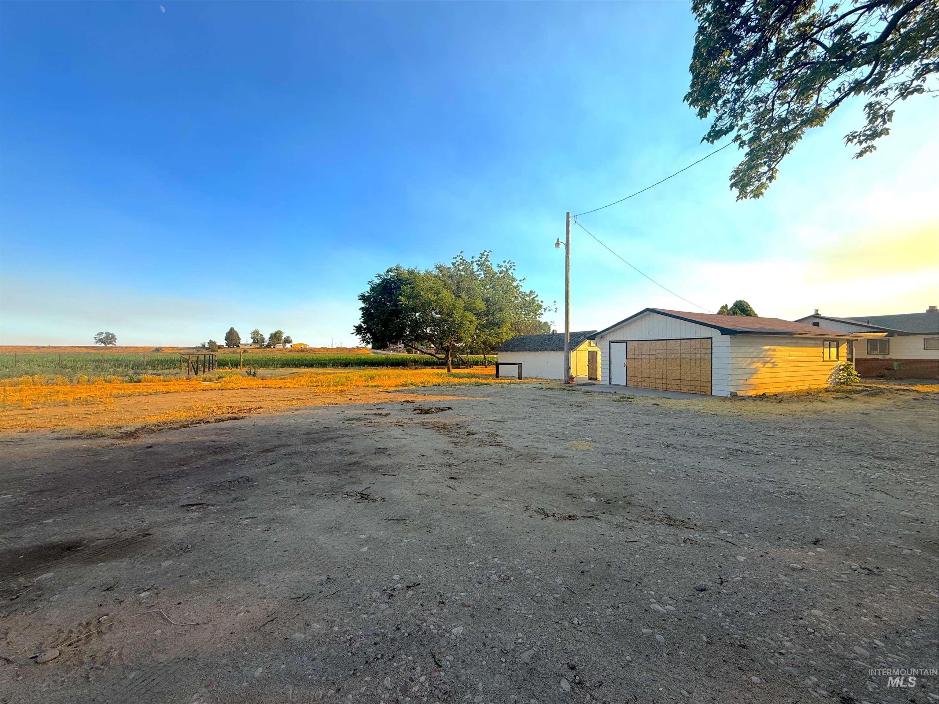 20898 Middleton Road Caldwell, ID 83605 - Photo 23 of 27 Expansive outdoor space featuring mature trees and a clear sky, offering an open horizon