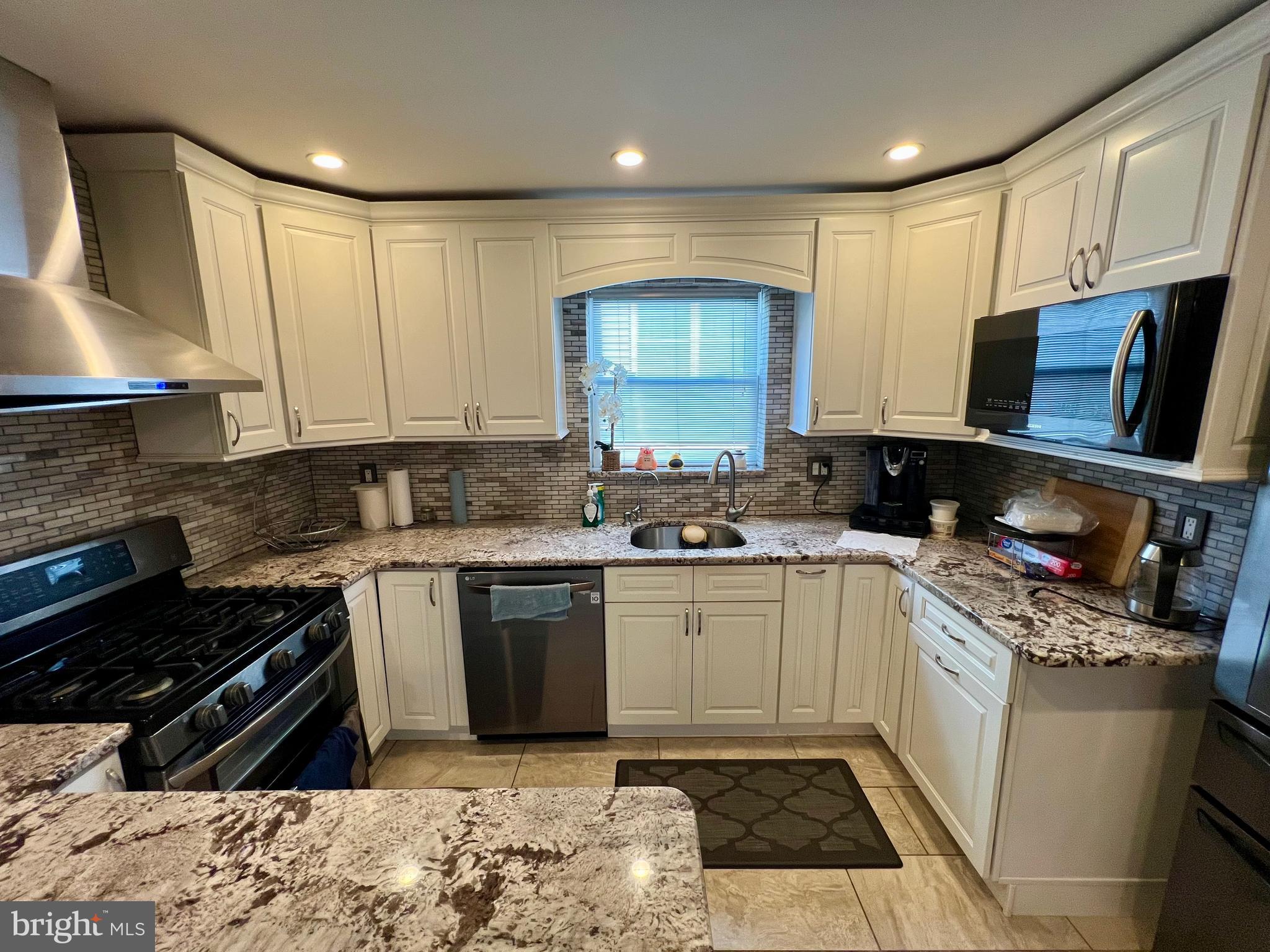 2988 Welsh Road Philadelphia, PA 19152 - Photo 12 of 38 a kitchen with a sink stove top oven and cabinets