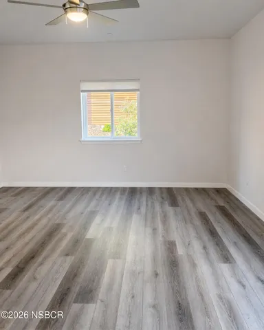 a view of an empty room and wooden floor