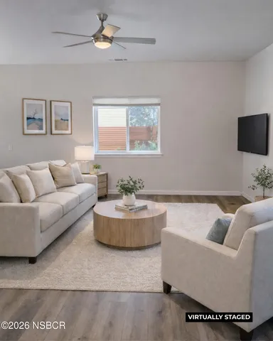 a living room with furniture and a potted plant