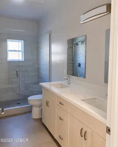 a bathroom with a toilet a sink and shower