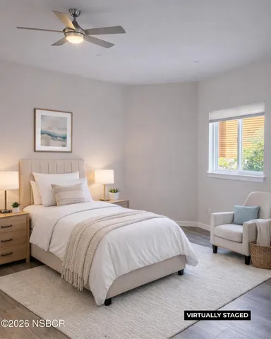 a bedroom with a bed couch and window