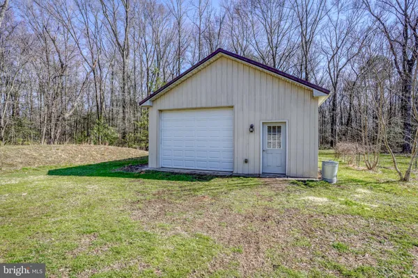 a view of backyard of house with green space