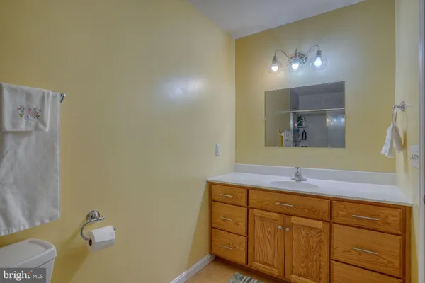 a bathroom with a sink vanity and mirror