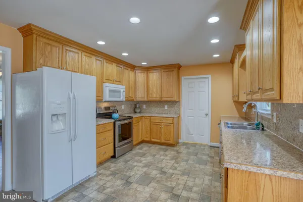 a kitchen with a refrigerator sink and stove