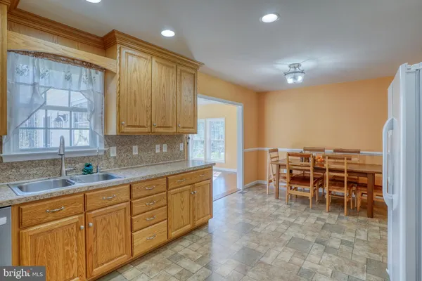 a kitchen with stainless steel appliances granite countertop sink and cabinets
