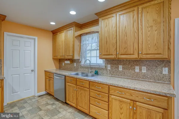 a kitchen with stainless steel appliances granite countertop cabinets and window